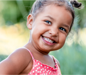 4 year old smiling wide outdoors
