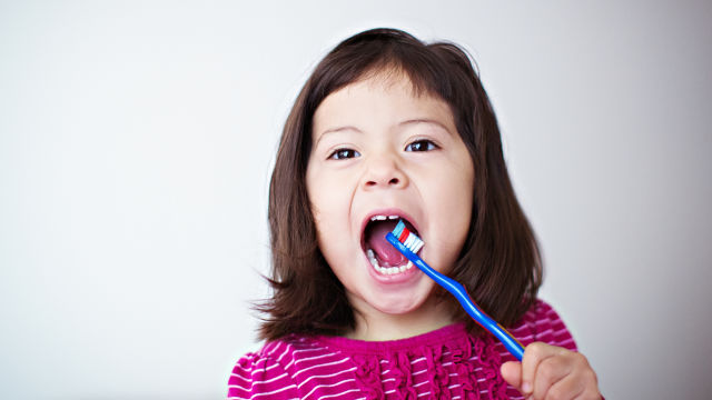 girl brushing her teeth