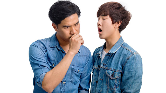 Two young men testing their breath
