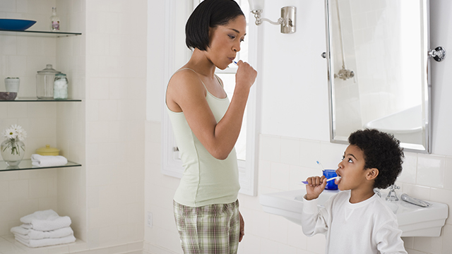 Mother and son brushing their teeth 
