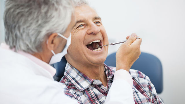 dentist checking his patient's teeth