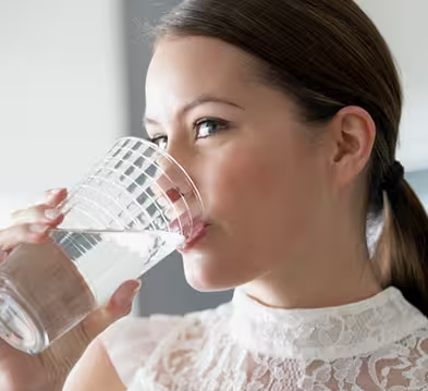 woman drinking a glass of water